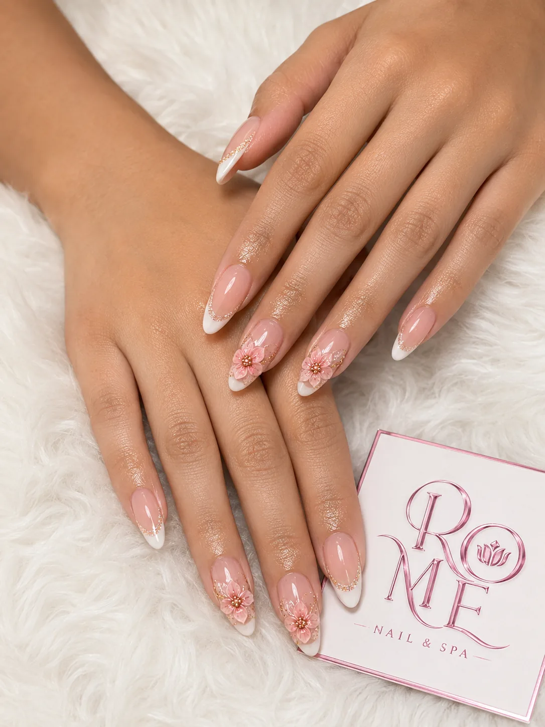 Blush pink almond nails with delicate floral details by Rome Nails Spa