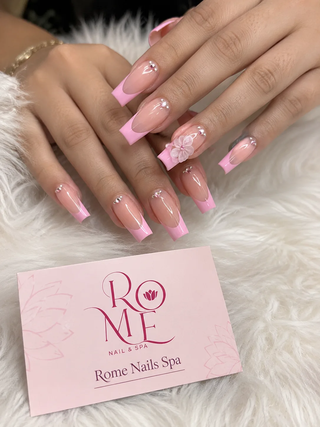 Crimson floral stiletto nails with crystal accents by Rome Nails Spa